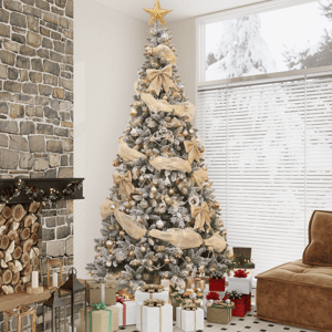 A lavishly decorated Christmas tree with a gold star topper, bows, and ornaments stands beside a stone fireplace. Wrapped gifts are arranged at the base, creating a cozy holiday atmosphere.