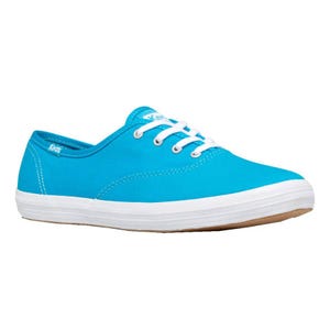 Bright blue canvas sneakers with white laces and a white rubber sole, featuring the Keds logo on the side.