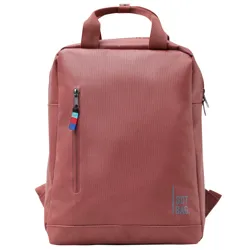 A rust-colored backpack with a top handle, a front zip pocket featuring a multicolored pull tab, and a printed \“GOT BAG\“ logo.