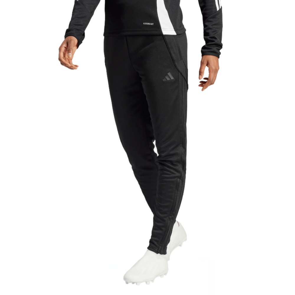 Black athletic joggers featuring the Adidas logo on the right thigh, worn with a matching black long-sleeve top and white athletic shoes.