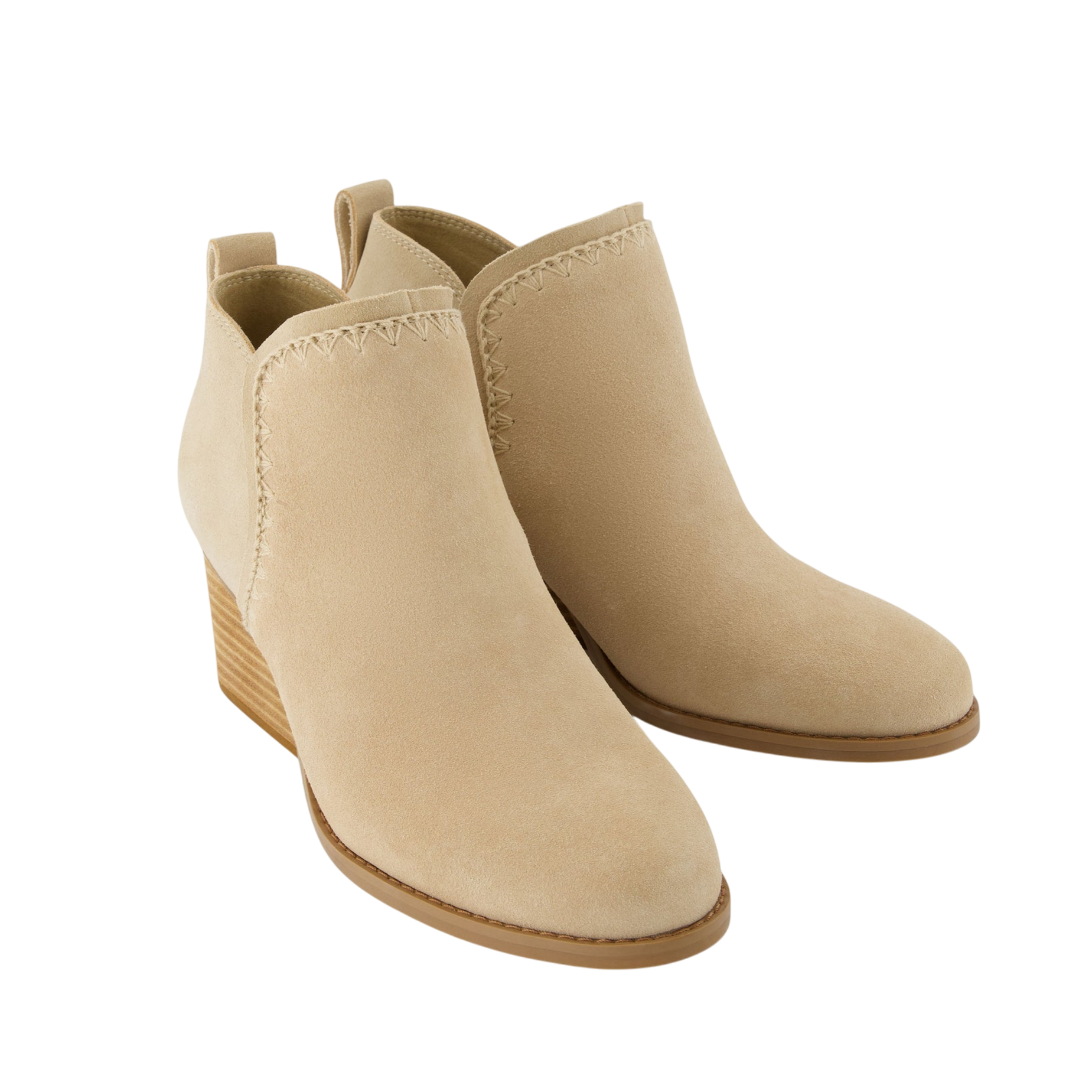 Beige suede ankle boots with low stacked heels and decorative stitching along the top edge.