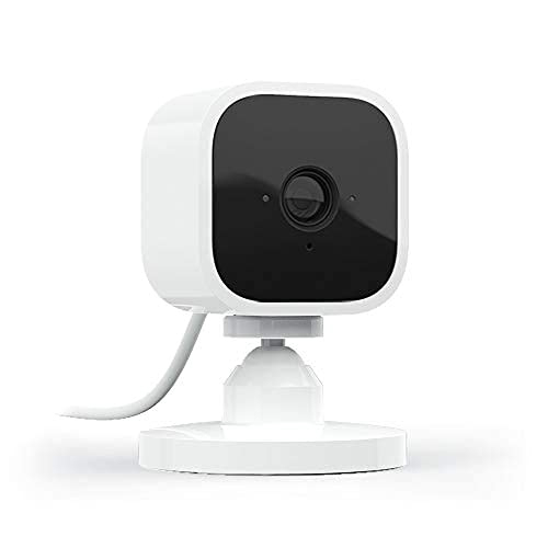 White and black compact security camera with a stand and cable.