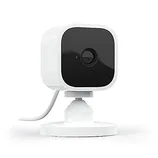 White and black compact security camera with a stand and cable.