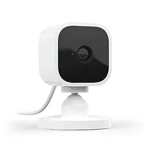 White and black compact security camera with a stand and cable.
