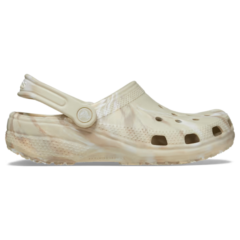 Crocs Marbled Clogs feature a beige and light brown marbled pattern, a perforated upper for breathability, and a convertible heel strap for a secure fit.