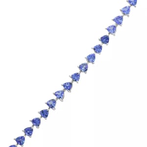 A bracelet featuring heart-shaped blue gemstones set in a silver-tone metal.