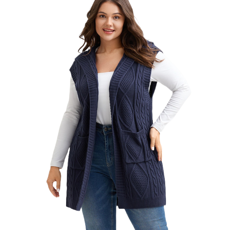 Dark blue knit sleeveless vest with cable pattern, featuring two front pockets, worn over a white long-sleeve shirt and jeans.