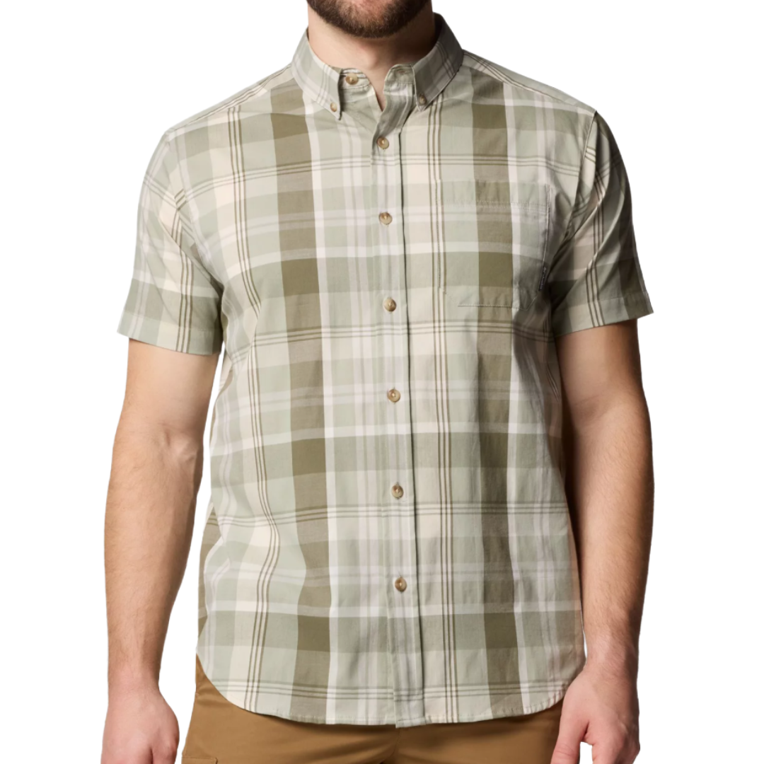 A short-sleeve plaid button-up shirt in green and beige tones, paired with brown pants.