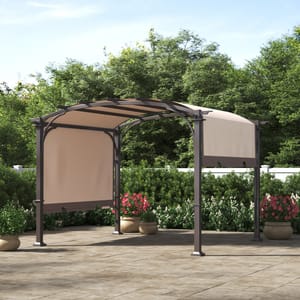 This is a steel pergola with a retractable canopy, situated on a patio area surrounded by greenery and potted plants.