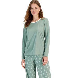 A two-piece pajama set featuring a sage green long-sleeve top with a white neckline and matching pants adorned with a subtle pattern of small white Christmas trees.