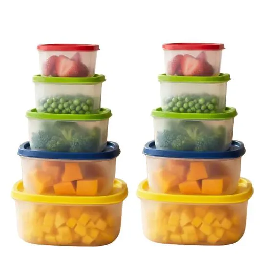 A stack of colorful, plastic food storage containers with lids, containing strawberries, green peas, broccoli, and cubed cheese. The containers are arranged in two identical stacks.