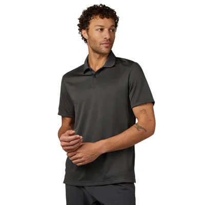 A man is wearing a dark gray short-sleeve polo shirt with a simple collar design.