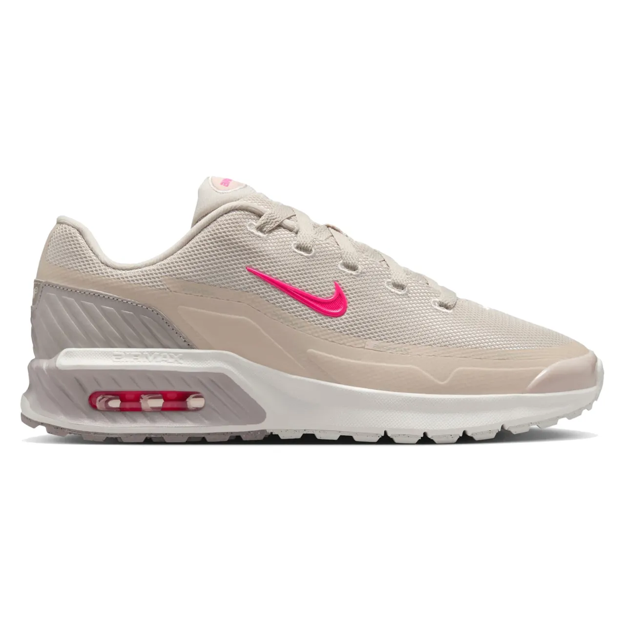 Nike Air Max Excee shoe in beige with a pink Swoosh logo, featuring a visible Air unit in the heel and a textured sole for grip.
