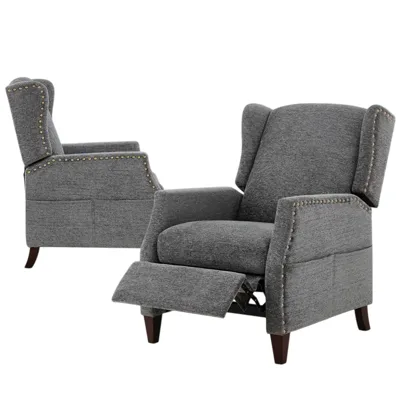 Two gray reclining armchairs with wingback design and brass nailhead trim, featuring wooden legs and upholstered fabric.