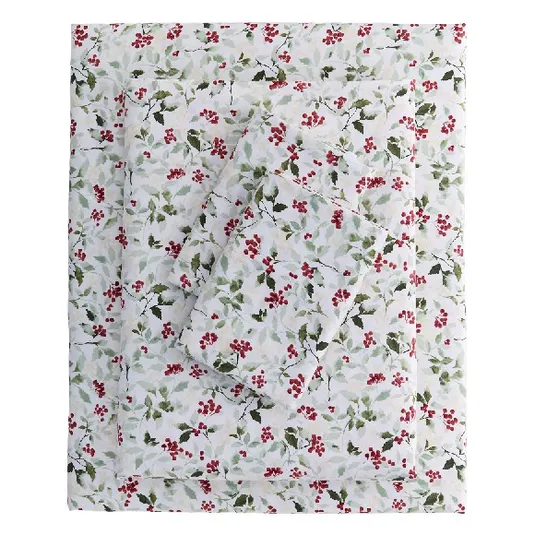 A bedding set featuring a floral pattern with red berries and green leaves on a white background.