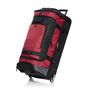 A large red and black wheeled duffel bag with multiple compartments, zippers, and compression straps, designed for easy transportation.