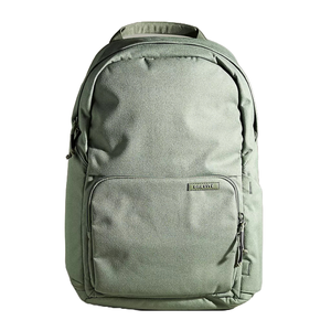 A light green Brevite backpack with a minimalist design features a main compartment, a front zippered pocket, and a subtle logo tag. It has a top handle and side pockets for additional storage.