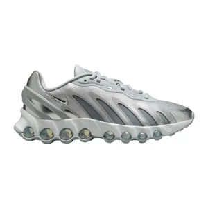A silver Nike sneaker with a futuristic design features multiple visible air pods in the sole and the iconic swoosh logo.