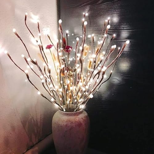 A vase filled with lighted LED branch decorations, featuring multiple branches with illuminated tips, creating a warm and cozy atmosphere.