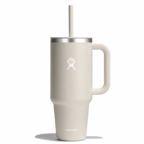 Beige Hydro Flask tumbler with a handle, lid, and straw, featuring the brand's logo.