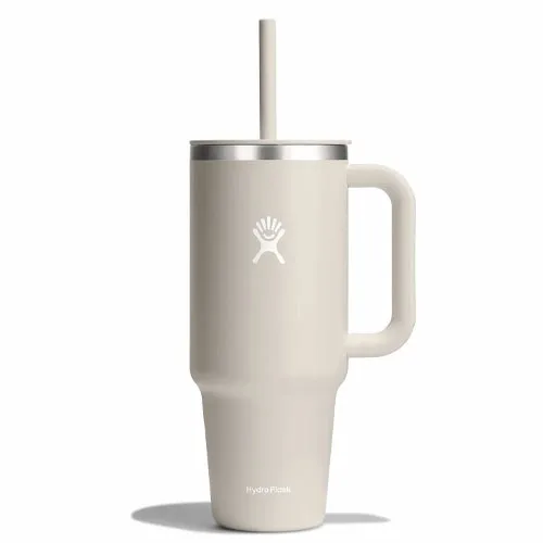 Beige Hydro Flask tumbler with a handle, lid, and straw, featuring the brand's logo.