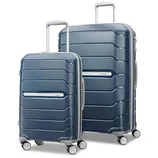 Two blue hard-shell suitcases with horizontal ridges, featuring telescopic handles and four wheels each. The smaller suitcase is placed in front of the larger one.