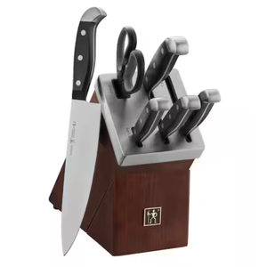 A 7-piece self-sharpening knife block set featuring a chef's knife, several utility and paring knives with black handles, kitchen shears, and a wooden storage block with built-in sharpeners.