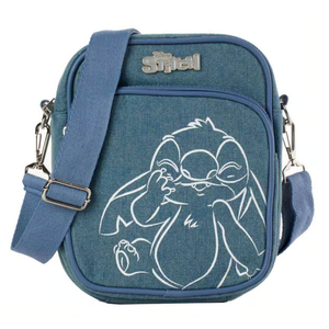 Lilo & Stitch Denim Crossbody features a blue denim exterior with an outline of Stitch on the front, an adjustable strap, and a \“Stitch\“ logo at the top. It includes a zippered main compartment and front pocket with silver hardware.