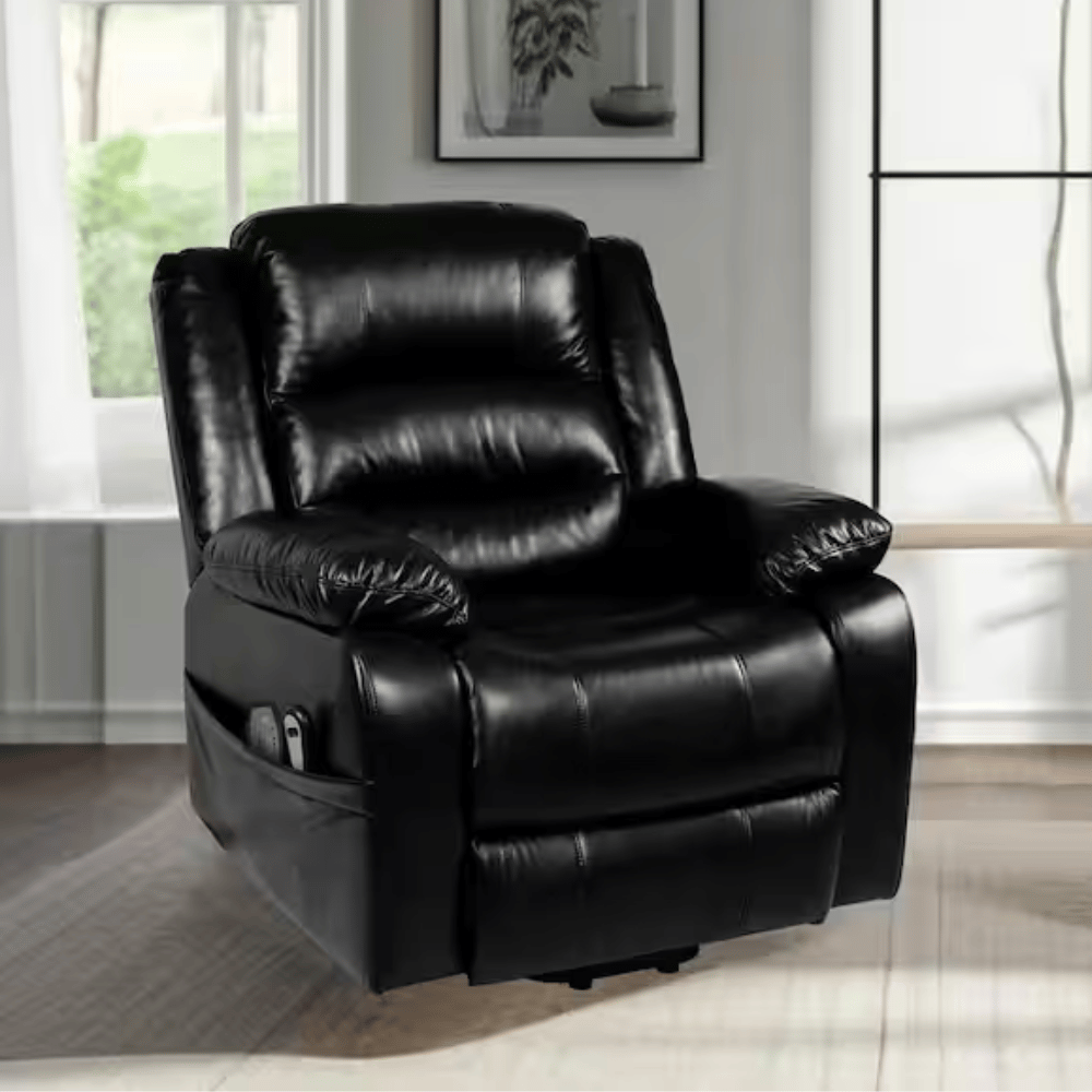 A black leather recliner with padded armrests and backrest, featuring a side pocket storage for remotes. Set in a modern living room with a window and framed artwork.