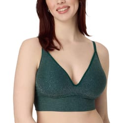 A woman wearing a sparkly green bralette with a V-neckline and thin straps.