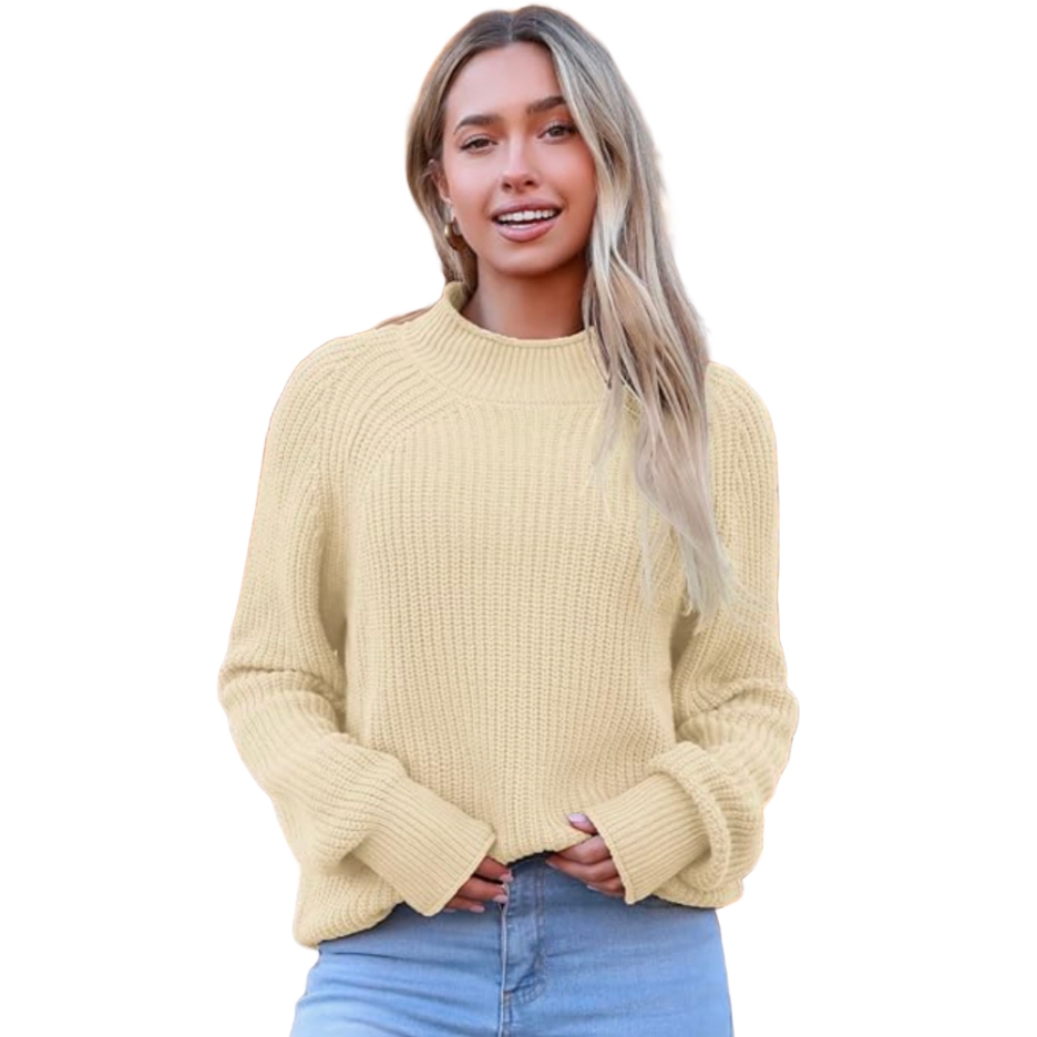 A woman is wearing a cream-colored, long-sleeve knit sweater paired with blue jeans.