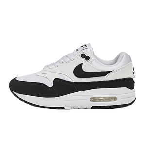A pair of Nike Air Max 1 sneakers in black, white, and grey with a visible Air cushioning unit in the heel.
