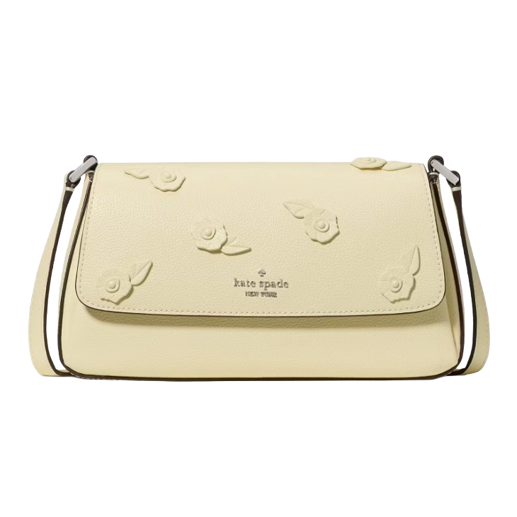A Kate Spade New York handbag in pale yellow, featuring floral embellishments on the flap and a thin shoulder strap.