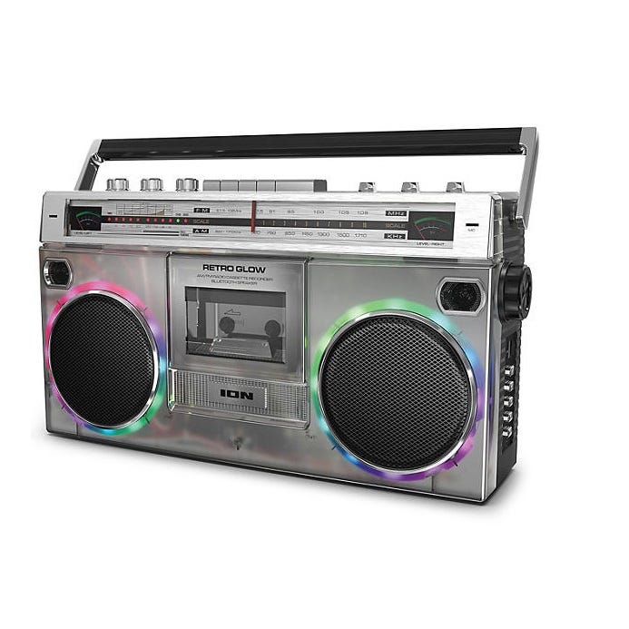 Retro Glow Bluetooth Speaker: Silver boombox design with cassette player and radio, featuring colorful LED lights around the speakers and a carry handle.