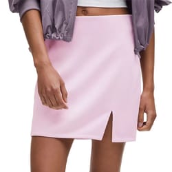 A light pink skirt with a front slit, paired with a cropped jacket.