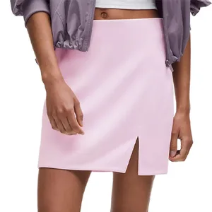 A light pink skirt with a front slit, paired with a cropped jacket.