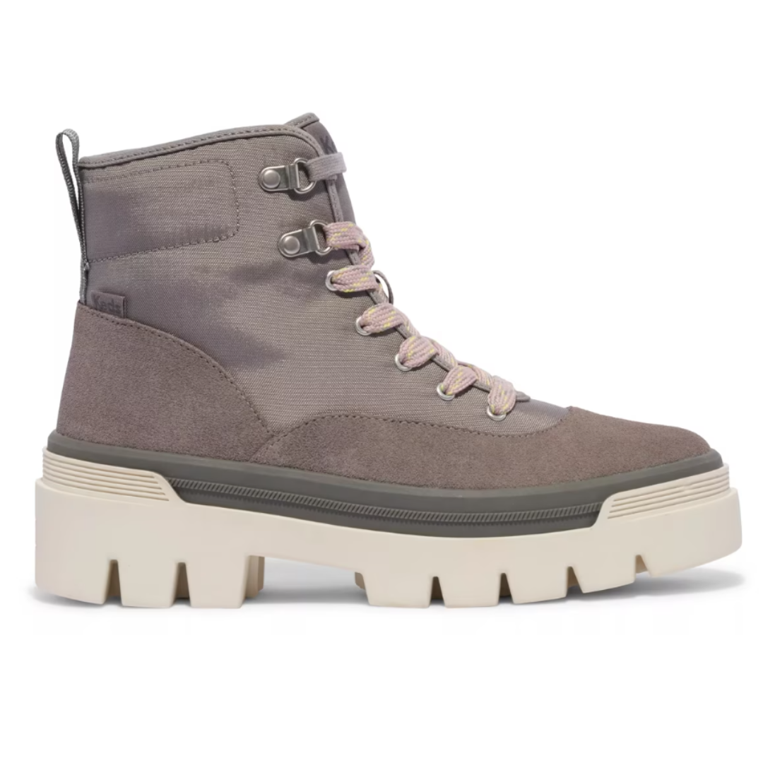 A stylish ankle boot featuring a light brown upper with pinkish laces, metallic eyelets, and a thick, chunky white sole for added height and traction.