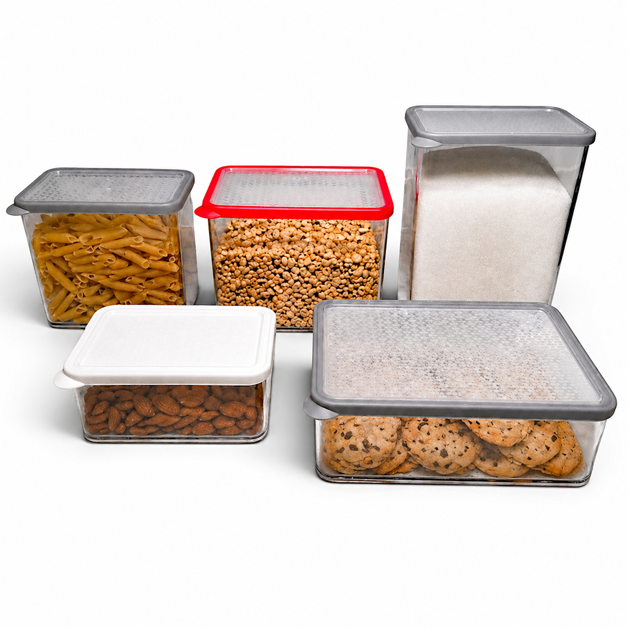 A set of clear, rectangular storage containers with colored lids, containing pasta, cereal, sugar, almonds, and cookies.