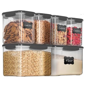 A set of six clear, rectangular food storage containers with black lids and labels indicating contents such as cookies, cereal, candies, and flour.