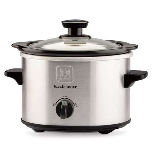 A small Toastmaster slow cooker with a stainless steel exterior, black handles, a glass lid, and a control dial with Low, High, and Off settings.