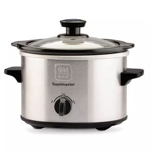 A small Toastmaster slow cooker with a stainless steel exterior, black handles, a glass lid, and a control dial with Low, High, and Off settings.