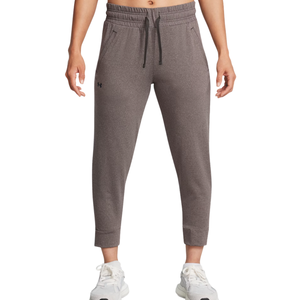 Dark gray joggers with a drawstring waistband, two side pockets, and a small logo on the left thigh. Paired with white sneakers.