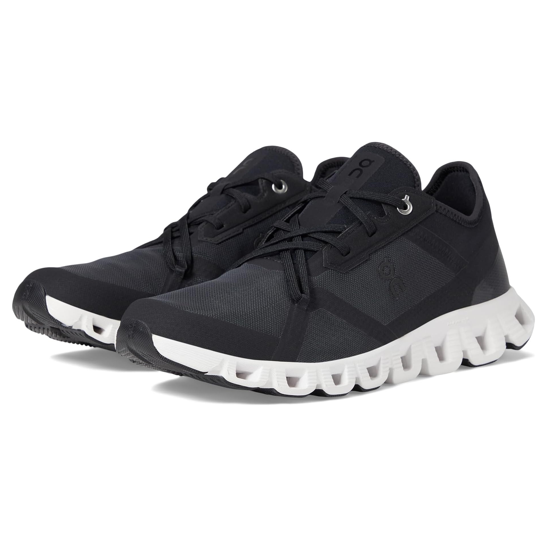 A pair of black athletic shoes with white soles and lace-up fronts.