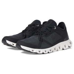 A pair of black athletic shoes with white soles and lace-up fronts.