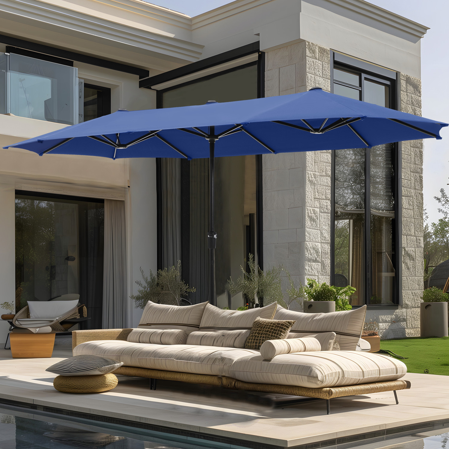 Outdoor patio setting featuring a large blue umbrella providing shade over a modern beige sectional sofa by a pool, against a contemporary house backdrop.