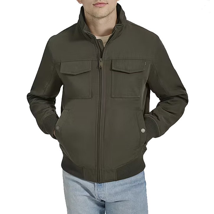 A Dockers water-resistant bomber jacket in olive green, featuring a full zip front, snap button pockets, a ribbed collar, cuffs, and hem. It is paired with light-wash jeans.