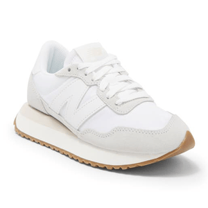 White New Balance 237 sneakers with a large 'N' logo on the side, a beige sole, and a gum rubber outsole.