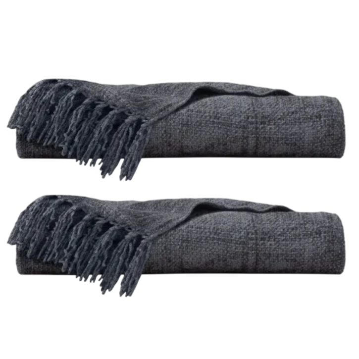 Two folded dark gray throws with fringed ends.