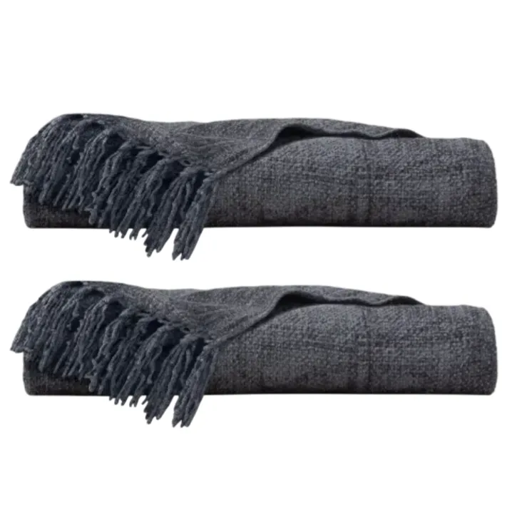 Two folded dark gray throws with fringed ends.