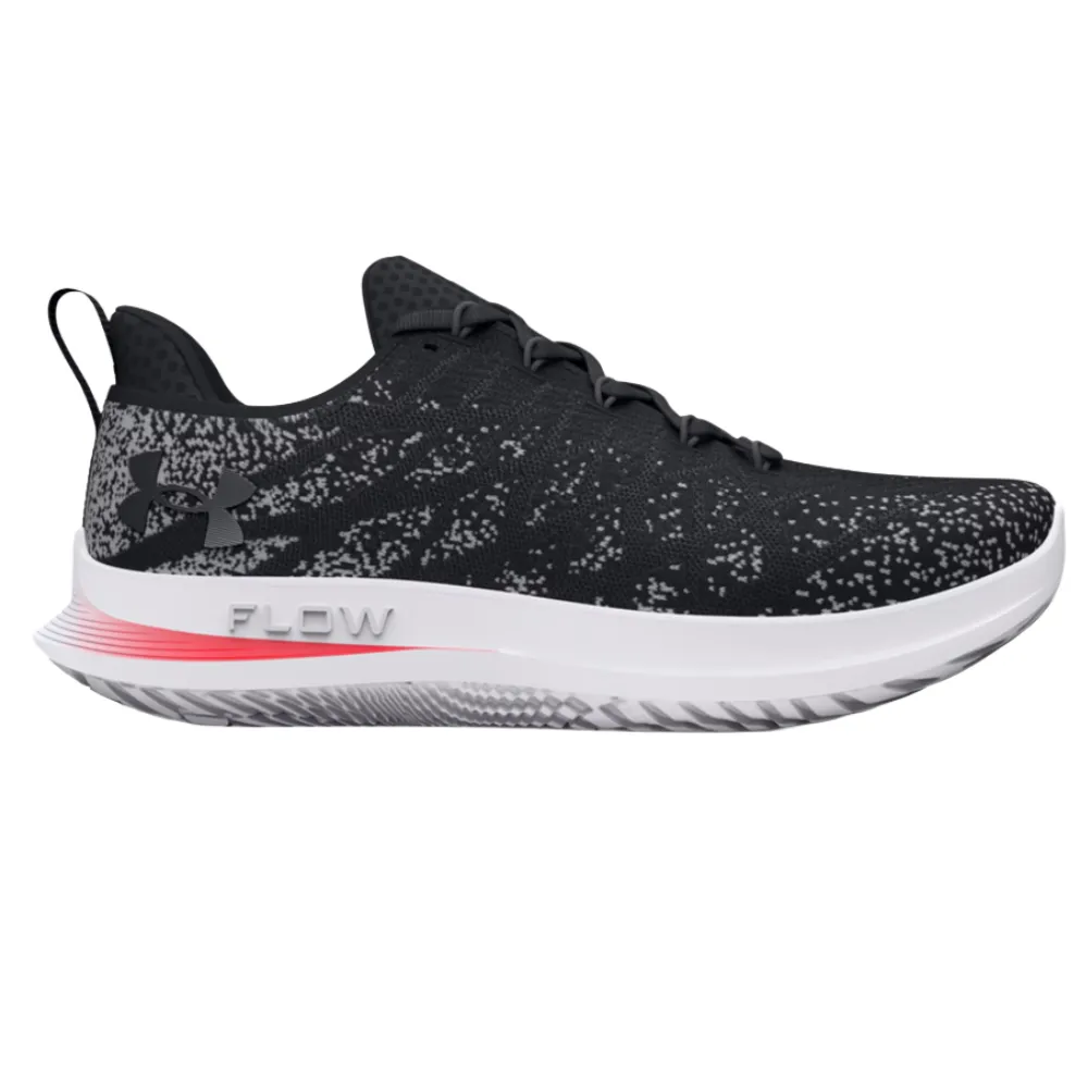 Under Armour running shoe, black with gray and white speckles, features a cushioned midsole labeled \“FLOW\“ and a black heel pull tab.